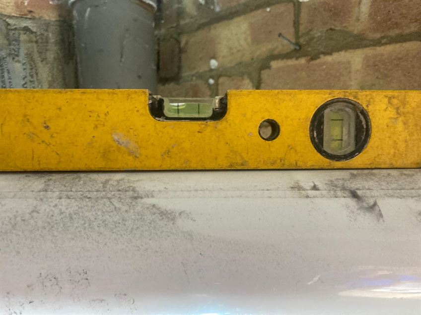 Spirit level showing an incorrect boiler flue fall during an inspection in Stevenage