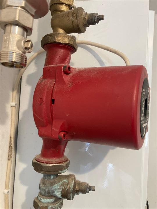 Existing red circulation pump before replacement at the St John’s Wood property