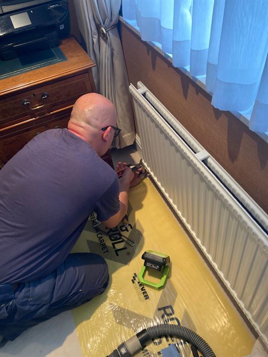 TNG Services engineer working on a radiator valve during the St John’s Wood heating upgrade