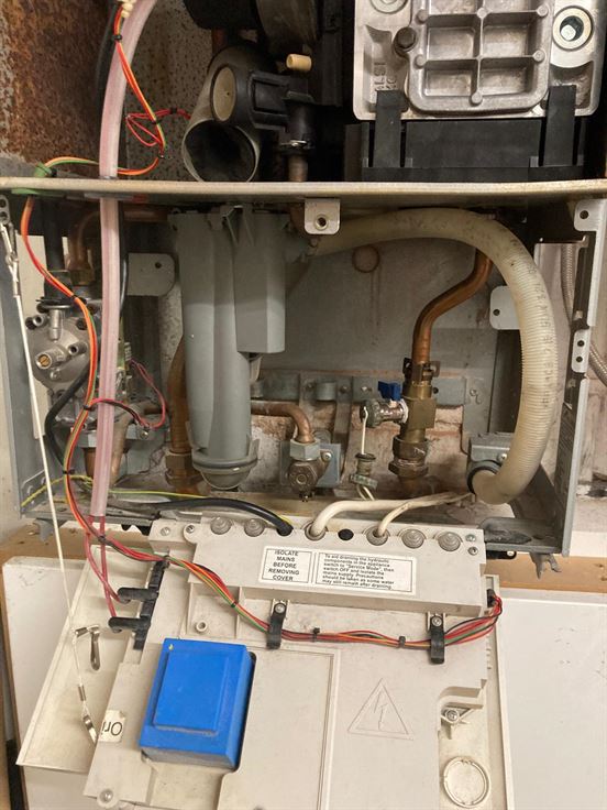 Internal components of the old Vaillant boiler exposed during the service