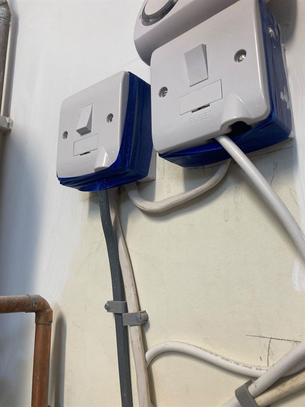 Fused spur faceplates with tape around the surface boxes