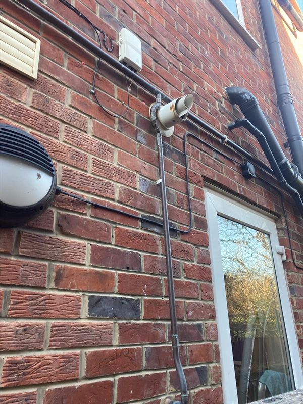 Existing external gas pipe route beside the boiler flue in Sunnyfield