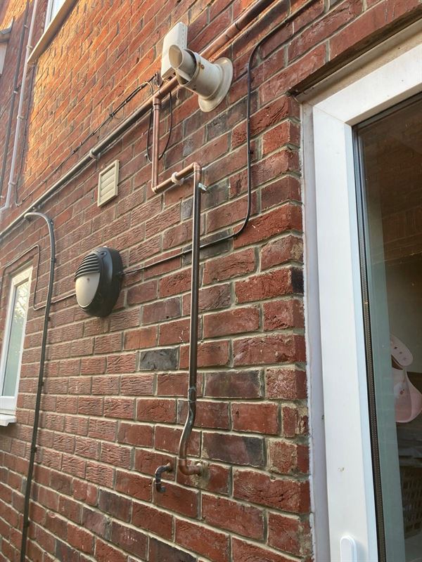 Rerouted external gas pipe near the boiler flue in Sunnyfield Mill Hill