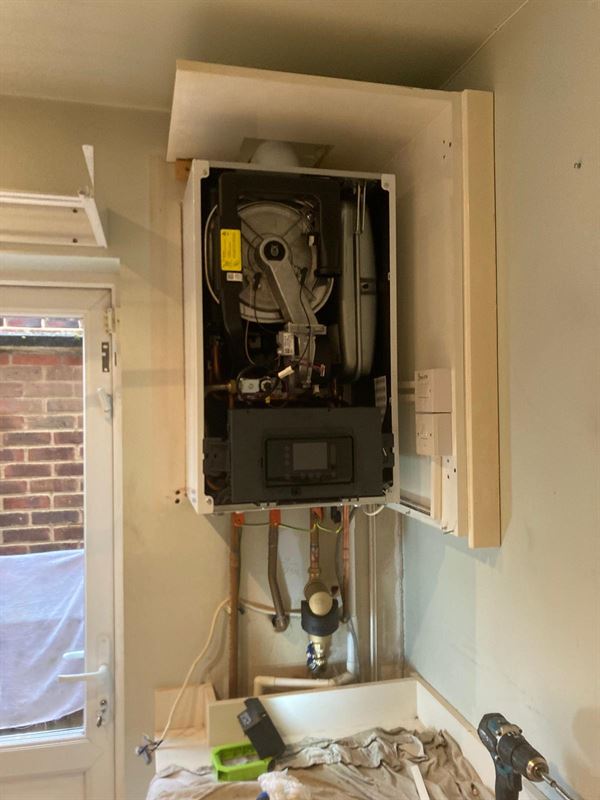 New Vaillant boiler with front casing removed during installation in Mill Hill