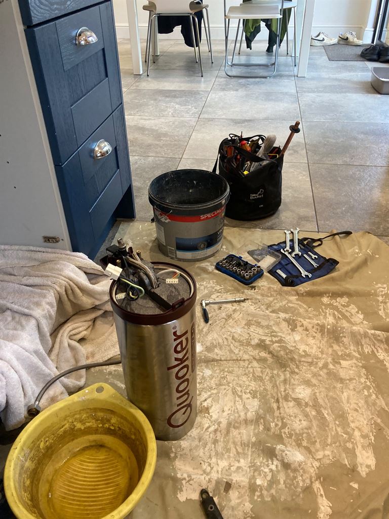 Quooker tank and service equipment on a protected kitchen floor
