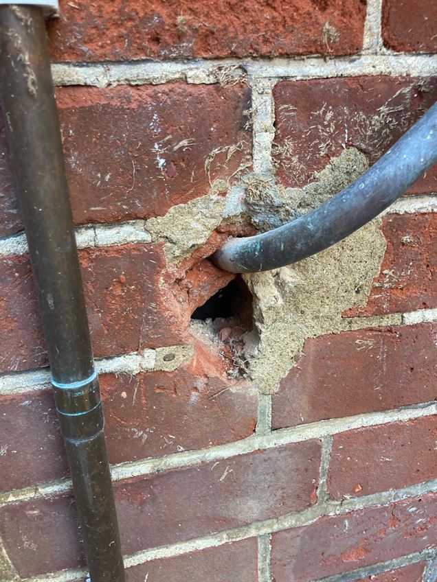 Existing gas pipe wall entry before the sleeving correction