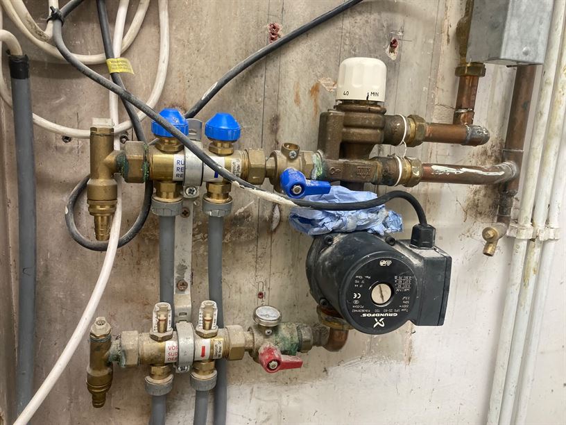 Existing underfloor heating manifold and circulation pump in Radlett
