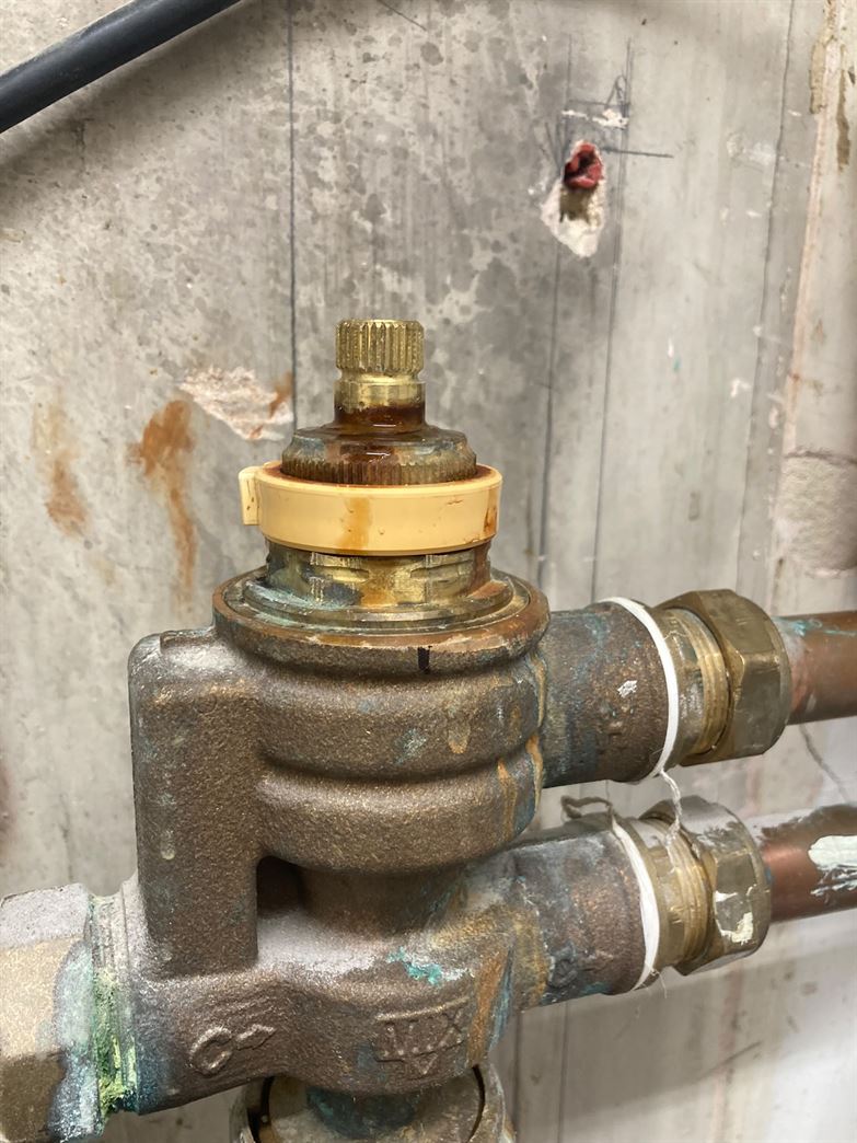 Close-up of an existing underfloor heating manifold valve