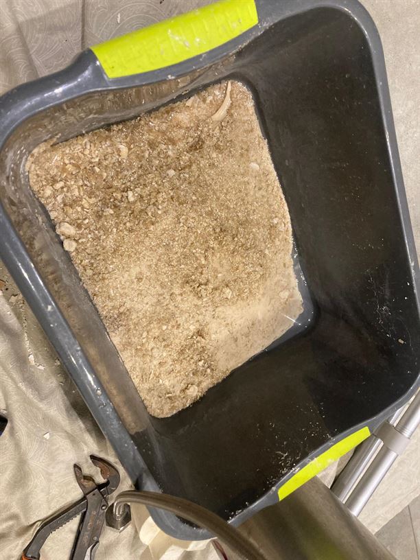 Limescale debris collected in a tray during the Quooker service