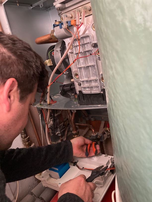 Engineer disconnecting the old Worcester Bosch boiler in Kentish Town